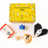 Showcasing all Pawsome Gift Box Products: 1. Barkday Toy 2. Pup face Candle 3. Royal Tuxedo Bandana 4. Gourmet Chicken Treats 5. Birthday Crown for Pet.